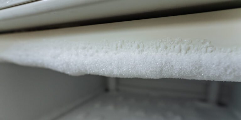 This closeup image highlights intricate frost formation in a freezer, stressing the importance of regular maintenance and defrosting for optimal appliance performance and efficiency at home